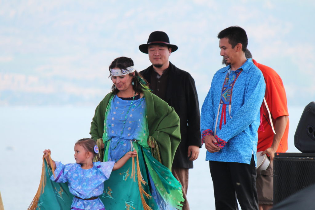 Jordan Coble looks on while his daughter performs with Cori Derrickson in her Salmon Dance